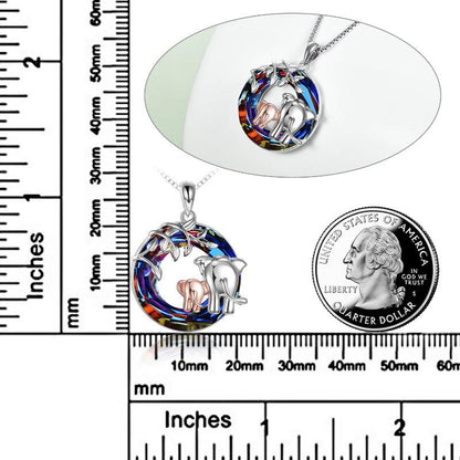 Elephant necklace with rulers next to it and a quarter dollar coin for size reference