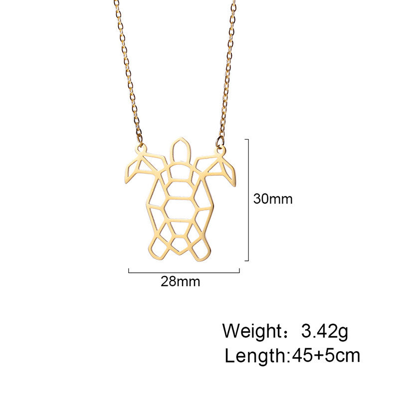 The gold turtle necklace laid out with its dimensions displayed